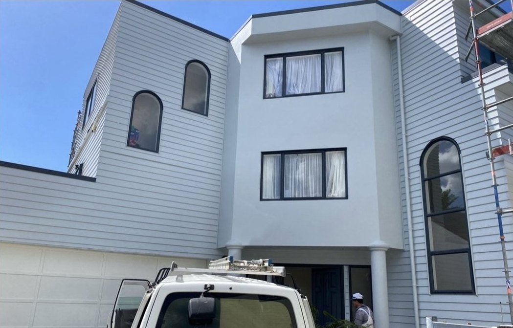 After: plaster and weatherboard townhouse, tired and then freshly painted white