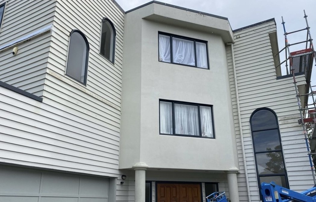 Before: plaster and weatherboard townhouse, tired and then freshly painted white