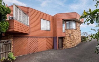Before: 1970s house with orange stained weatherboards, then repainted white with a black chevron garage door
