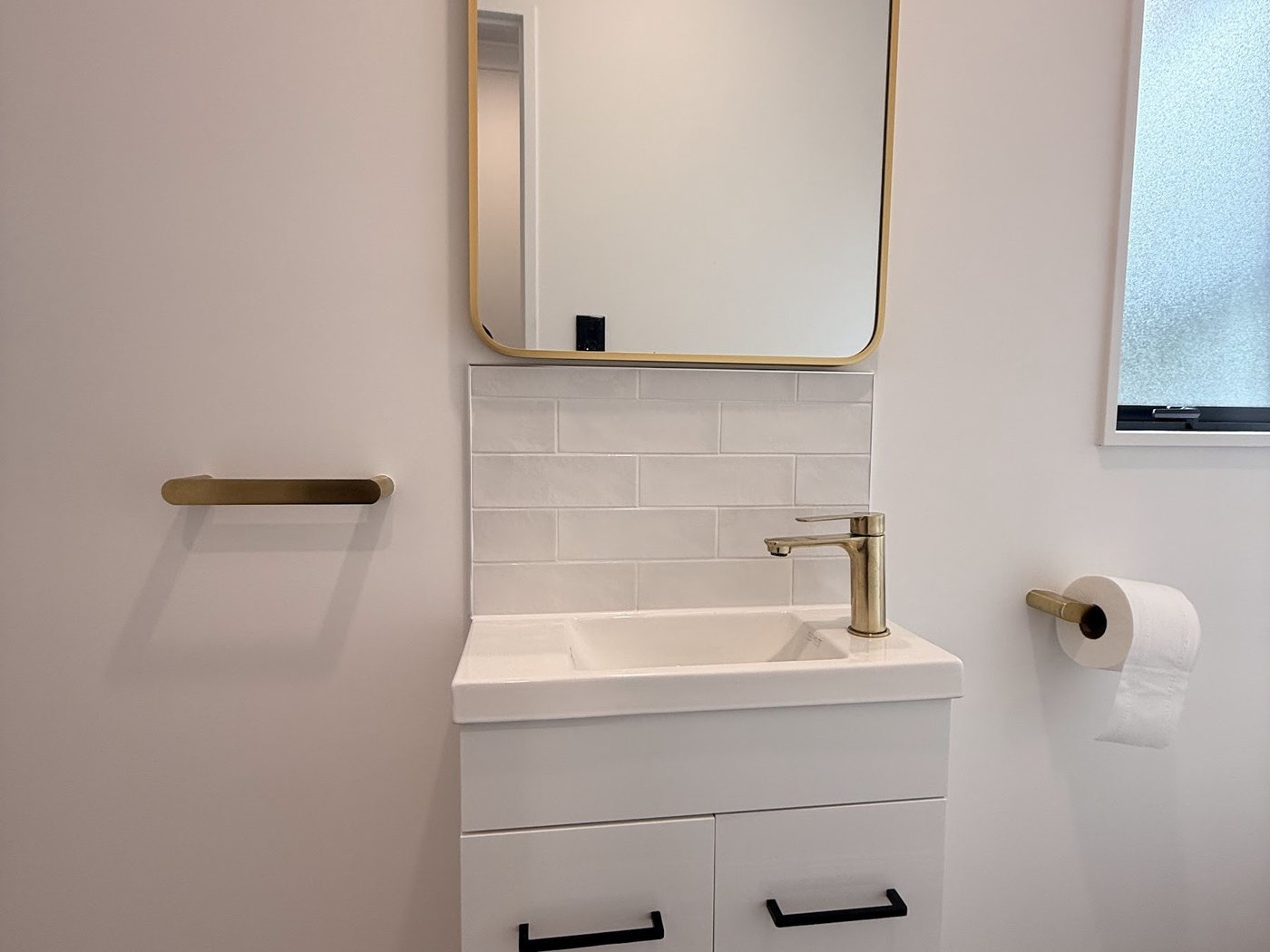 Freshly painted bathroom with a new vanity, finished by Living Colour